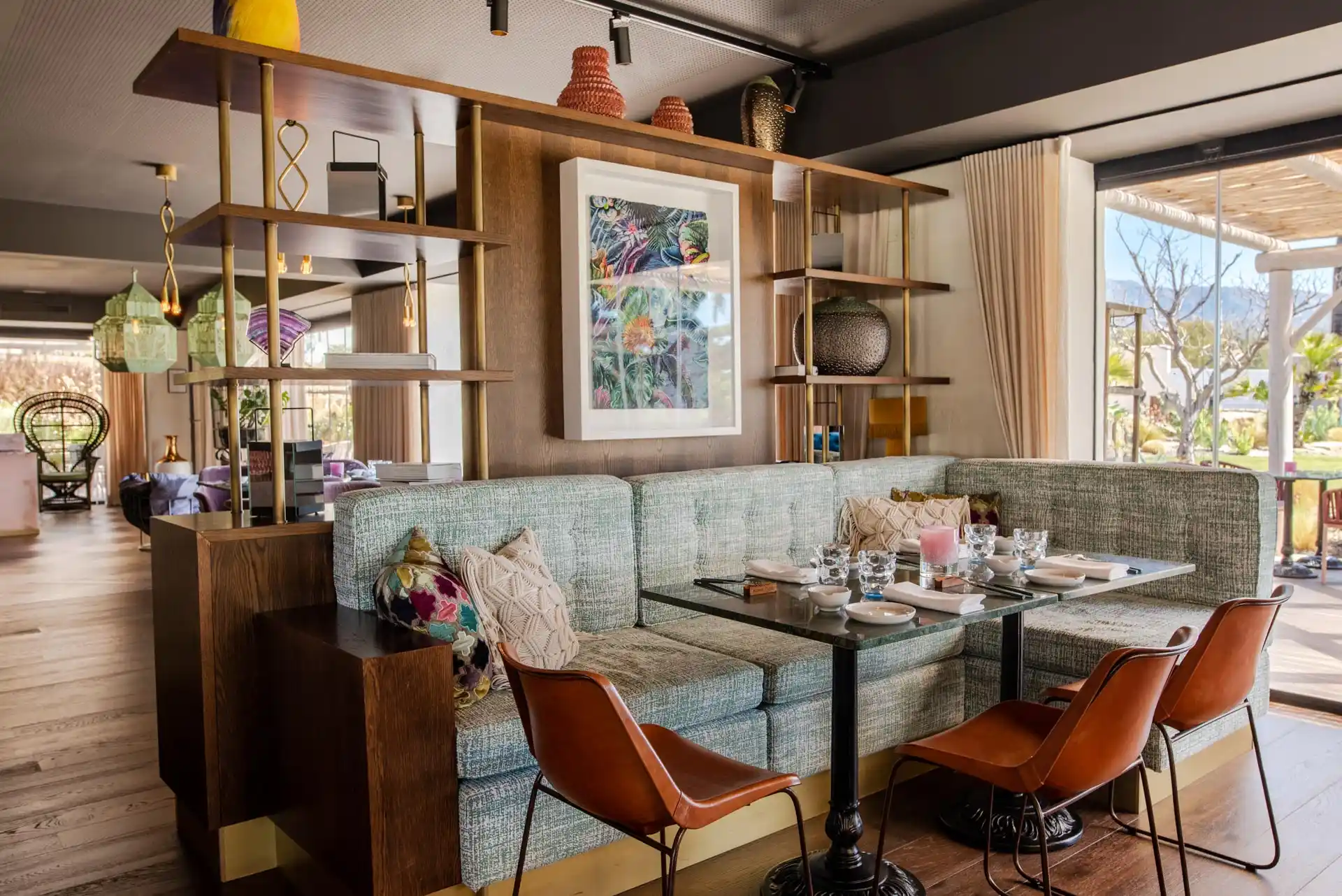 Restaurant lounge with banquette seating and artwork at Boho Club