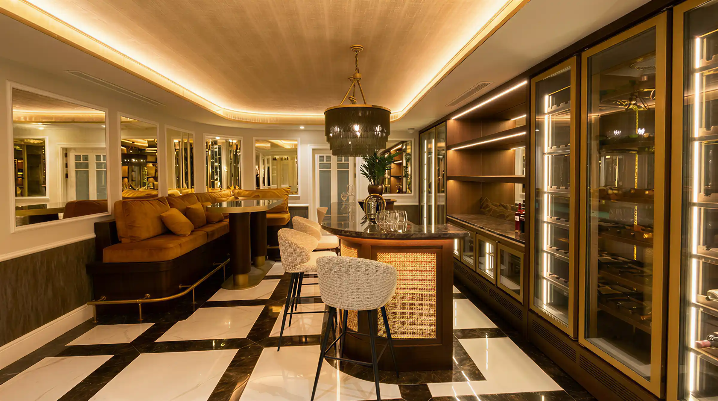 Basement bar and lounge with cove lighting and polished stone floor